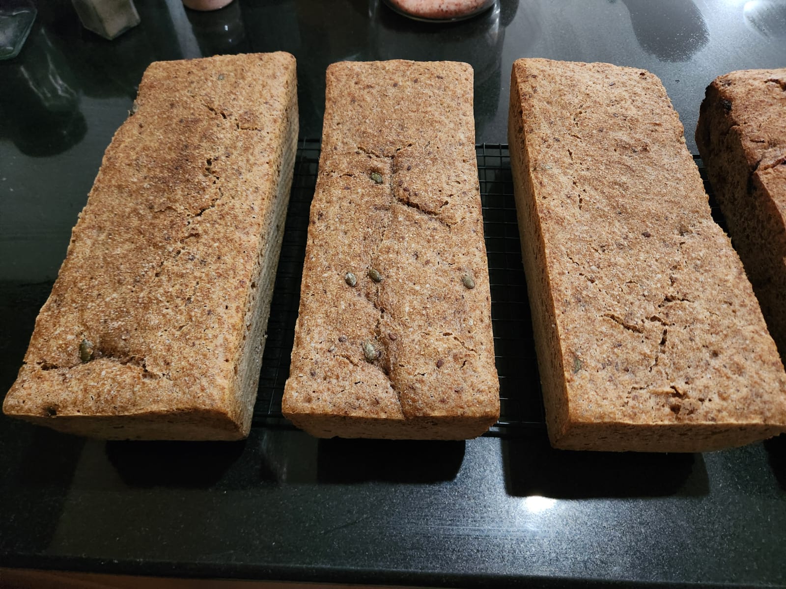 Seeded wholegrain loaves on a cooling rack